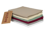 Stapel mit gefalteten Kissenbezuegen in den Uni-Farben Weiss, Hellgrau, Weinrot, Gruen, Natur und Beige.